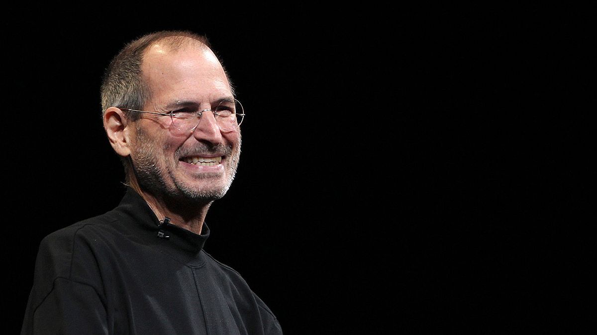a man smiling with glasses